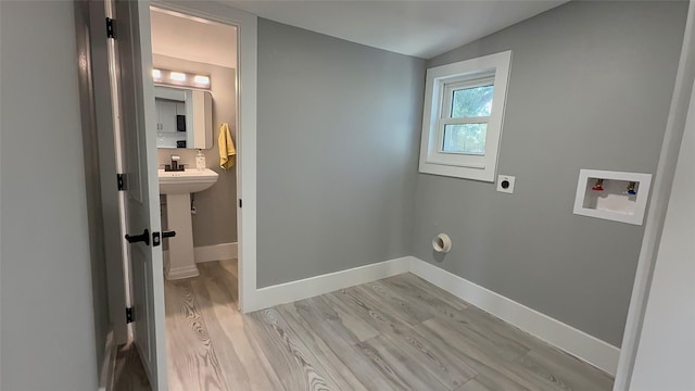 washroom with light wood-type flooring, washer hookup, and electric dryer hookup