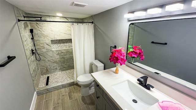 bathroom featuring vanity, a shower with curtain, and toilet