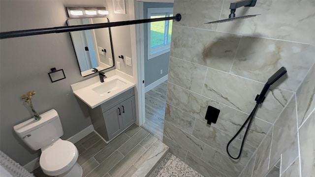 bathroom with vanity, toilet, and walk in shower