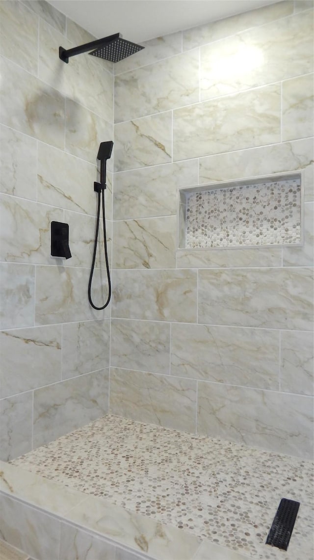 bathroom with a tile shower