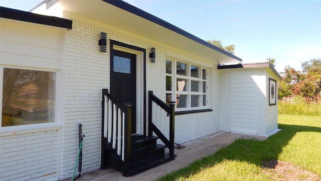 doorway to property featuring a yard