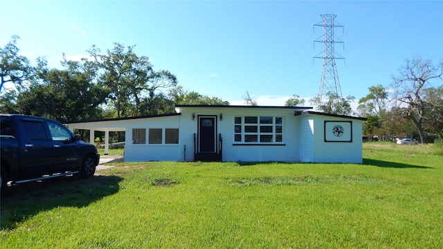 single story home with a front lawn and a carport