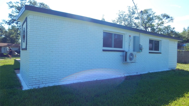 view of side of home with a yard and ac unit