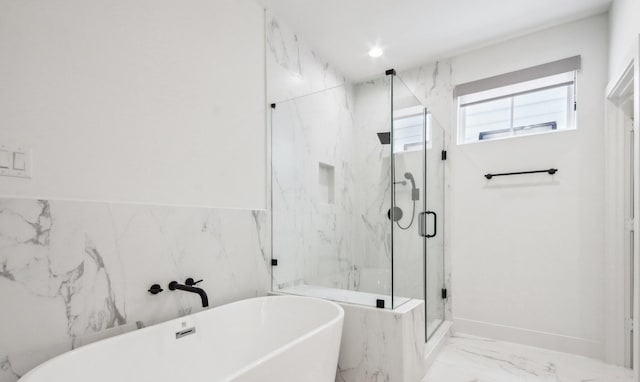 full bath featuring a marble finish shower, marble finish floor, a freestanding tub, tile walls, and recessed lighting