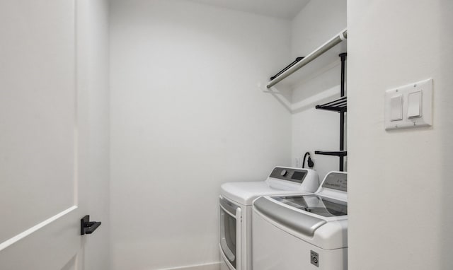 clothes washing area featuring laundry area and washing machine and dryer