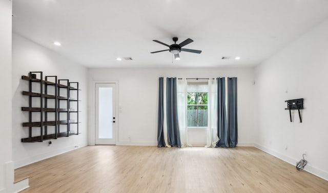 interior space with baseboards, wood finished floors, visible vents, and recessed lighting