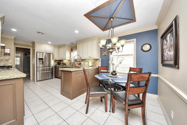 dining area featuring ornamental molding, a chandelier, light tile patterned flooring, and baseboards