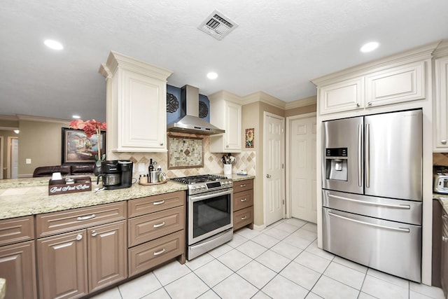 kitchen with light tile patterned floors, stainless steel appliances, visible vents, decorative backsplash, and wall chimney exhaust hood