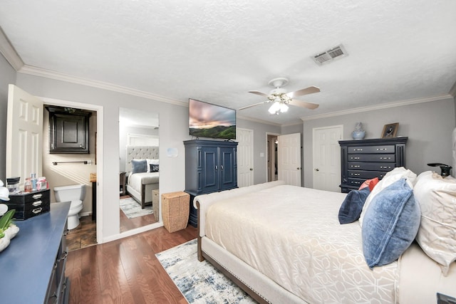 bedroom featuring dark wood-style floors, visible vents, ornamental molding, and a textured ceiling