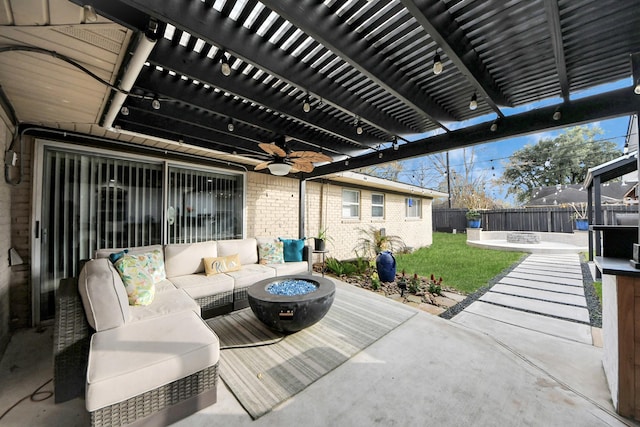 view of patio / terrace featuring an outdoor living space with a fire pit, a fenced backyard, and a pergola