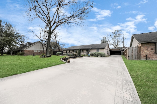 ranch-style house with a front yard and concrete driveway