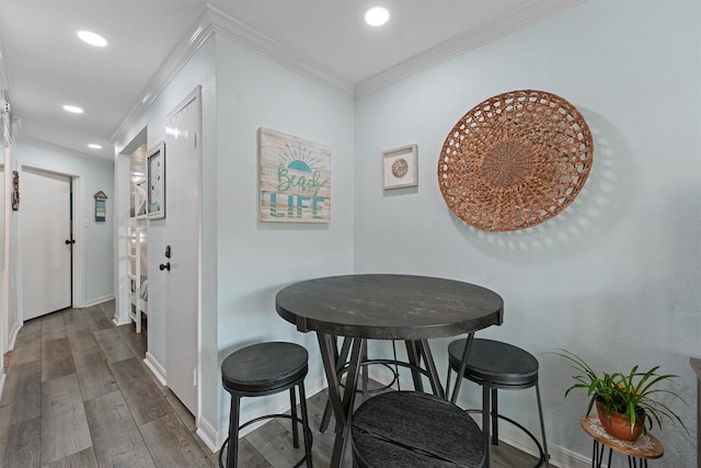 hall featuring dark wood-type flooring, recessed lighting, ornamental molding, and baseboards