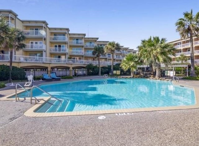 pool featuring a patio area and fence