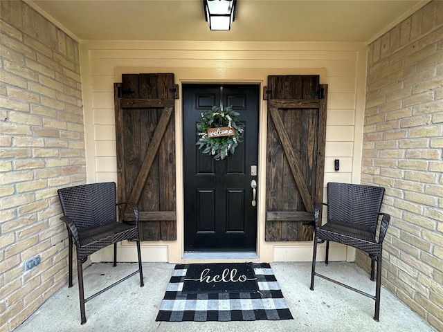 property entrance with brick siding