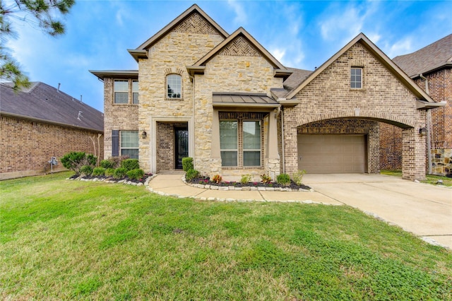 view of front facade with a front yard, concrete driveway, stone siding, and brick siding