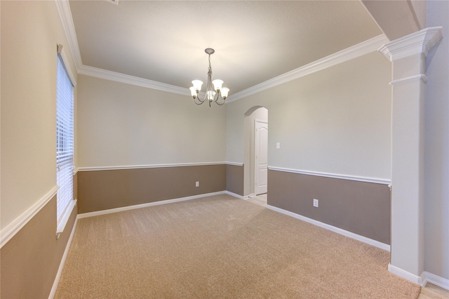 empty room featuring light carpet, crown molding, and baseboards