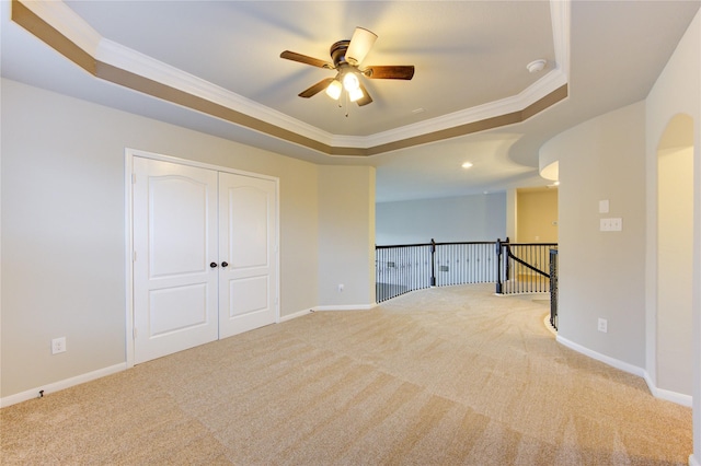 unfurnished room featuring ornamental molding, baseboards, and a tray ceiling