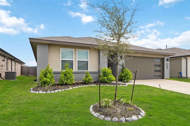 view of front of property featuring a front yard, a garage, and central AC unit