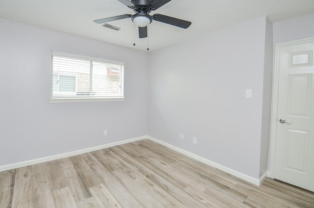 spare room featuring visible vents, baseboards, light wood-style flooring, and a ceiling fan