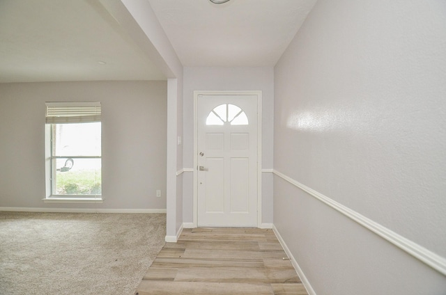 entryway featuring baseboards and light wood-style floors