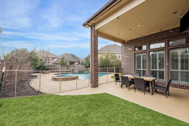 view of swimming pool with a patio area, a fenced backyard, a pool with connected hot tub, and a lawn