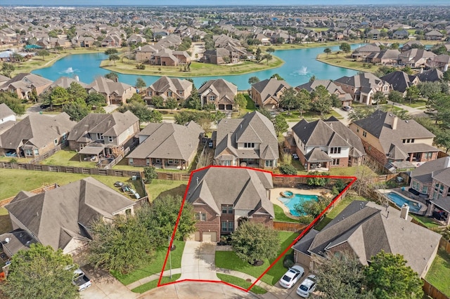 bird's eye view featuring a water view and a residential view