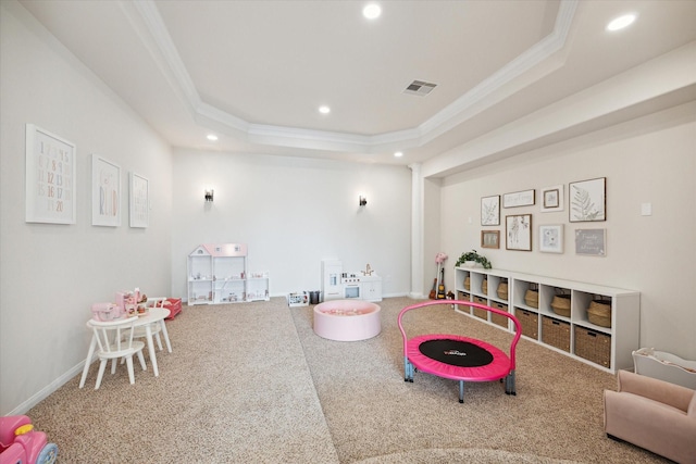 recreation room with a raised ceiling, crown molding, and recessed lighting