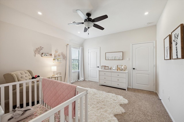 bedroom with recessed lighting, light colored carpet, a nursery area, and baseboards