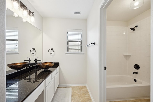 full bathroom with bathtub / shower combination, visible vents, plenty of natural light, and vanity