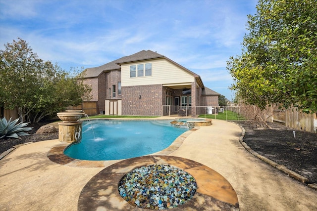 view of pool featuring a fenced backyard and a pool with connected hot tub