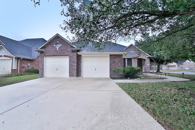 ranch-style house with a garage, brick siding, a shingled roof, concrete driveway, and a front yard