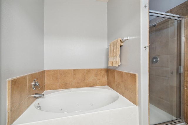 full bath featuring a whirlpool tub and a shower stall