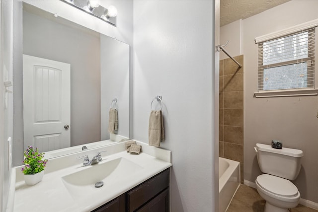 bathroom with baseboards, toilet, tile patterned floors, tub / shower combination, and vanity