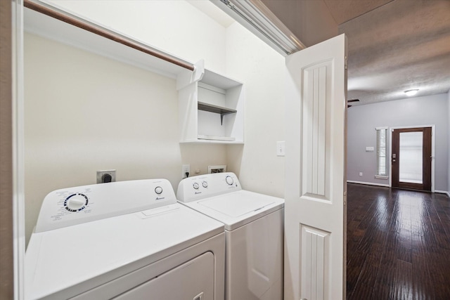 laundry area with laundry area, washing machine and dryer, and dark wood-style floors