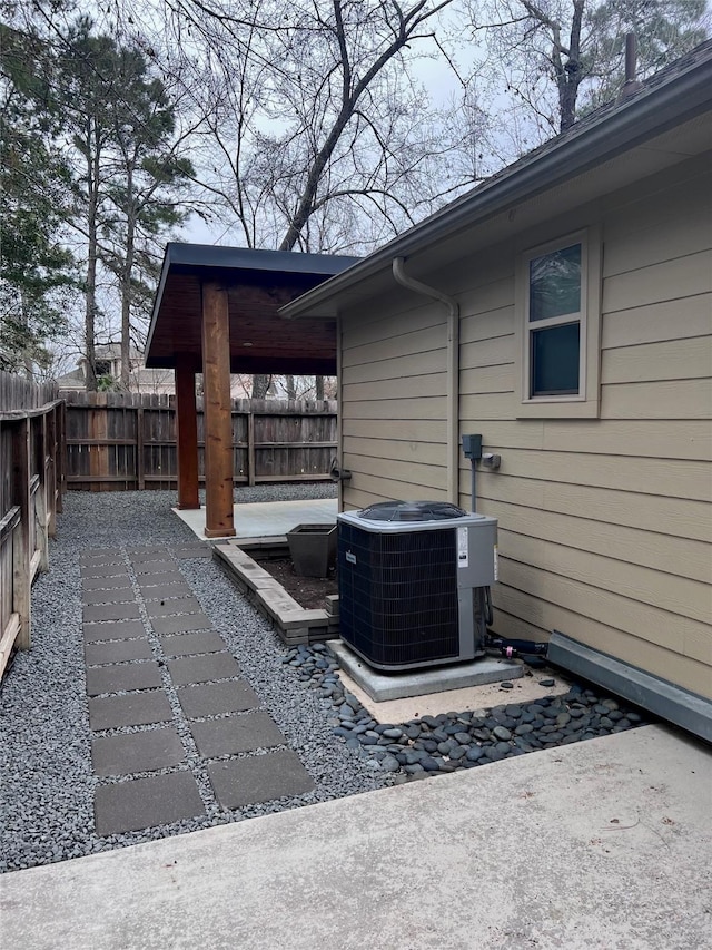 view of patio with a fenced backyard and central AC unit