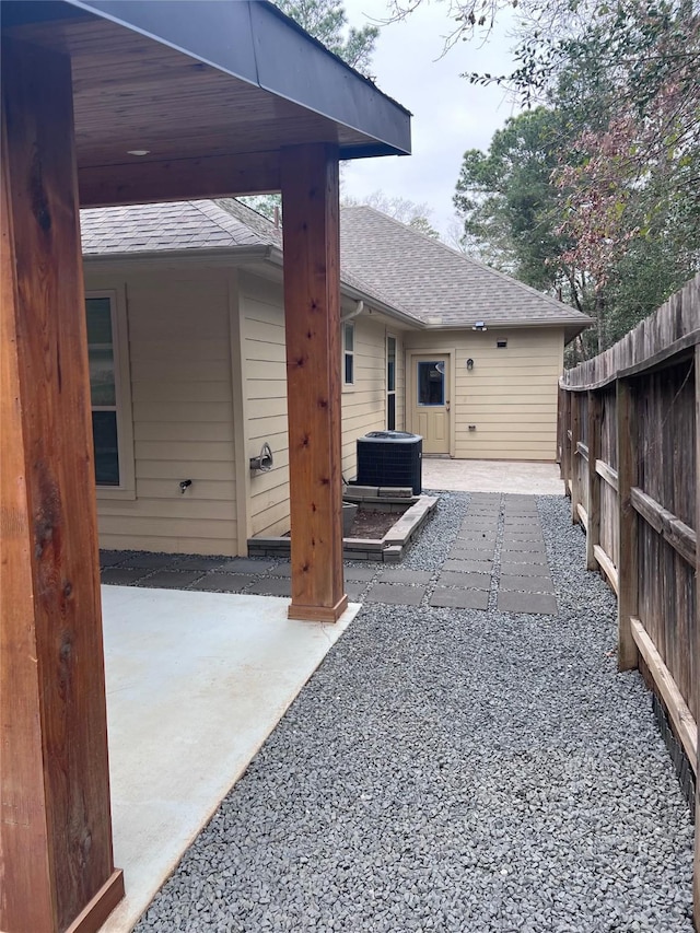 view of patio / terrace with fence and central air condition unit