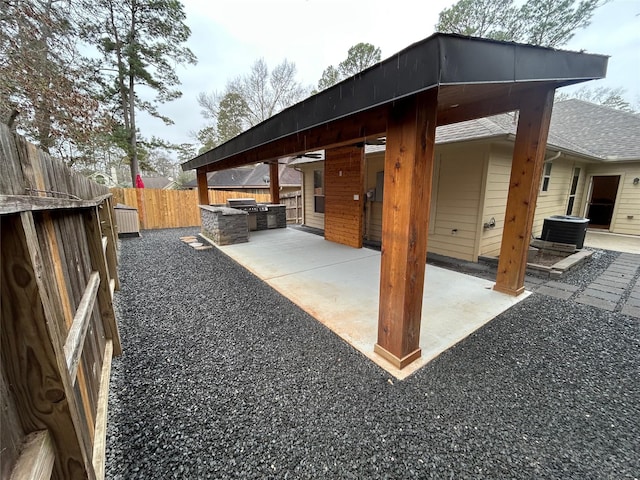 view of patio / terrace with central AC unit, area for grilling, and a fenced backyard