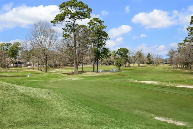 view of community featuring a lawn and golf course view