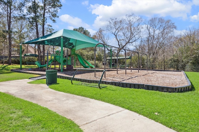 community playground featuring a lawn and fence