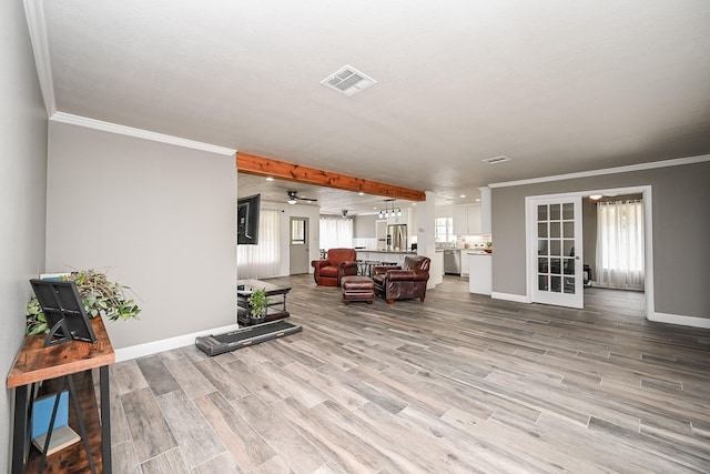 1133 Peebles St, Hempstead, TX 77445 - living room with baseboards, wood finished floors, crown molding, ceiling fan, and french doors