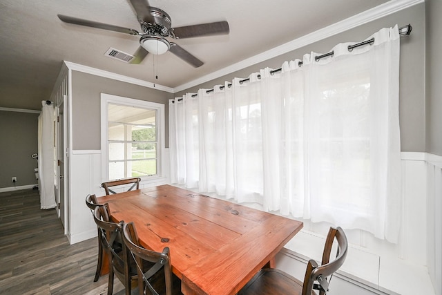1133 Peebles St, Hempstead, TX 77445 - dining room featuring ceiling fan, dark wood-style floors, crown molding, and a wainscoted wall