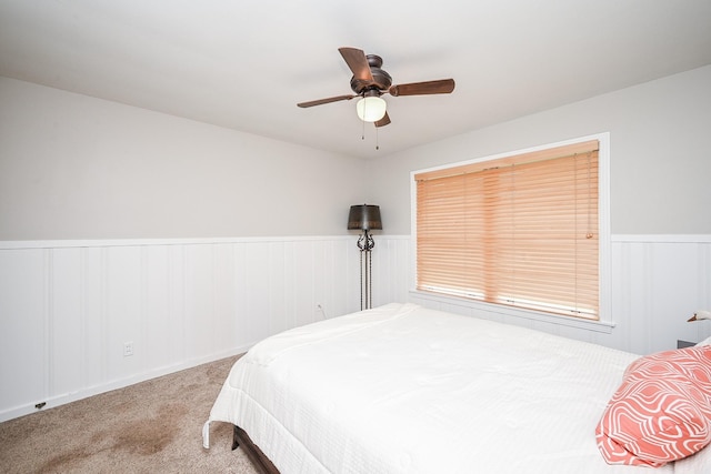 1133 Peebles St, Hempstead, TX 77445 - carpeted bedroom featuring wainscoting and ceiling fan