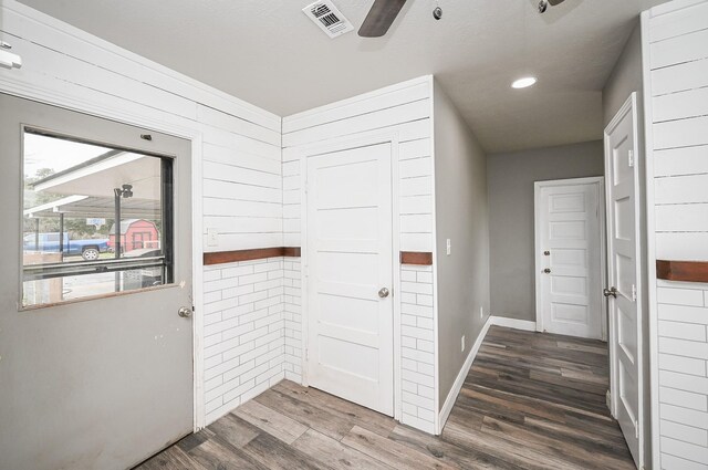 corridor featuring recessed lighting, visible vents, baseboards, and wood finished floors