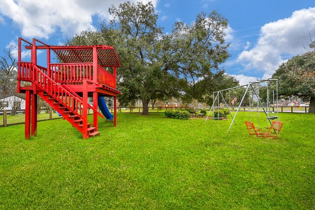 view of jungle gym with fence and a lawn