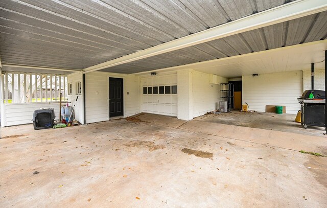 garage with an attached carport