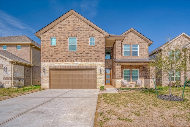 view of front of property with brick siding, a front yard, a garage, stone siding, and driveway