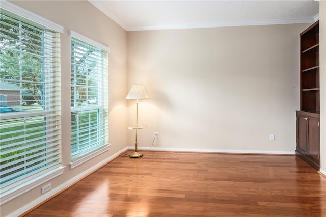 unfurnished room featuring hardwood / wood-style floors and ornamental molding