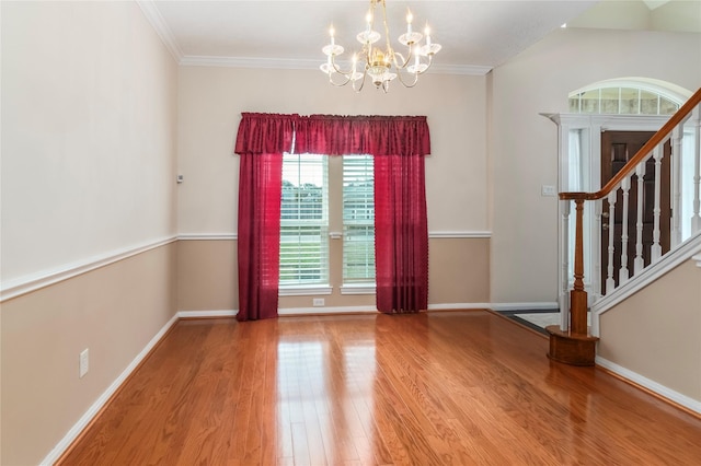 interior space with hardwood / wood-style floors, a chandelier, and ornamental molding