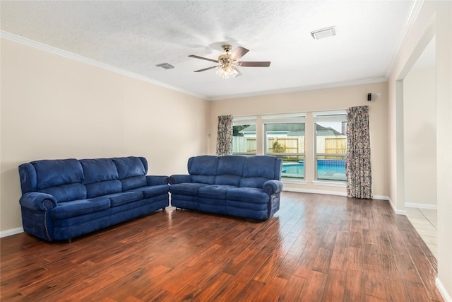 living room with a textured ceiling, crown molding, dark hardwood / wood-style floors, and ceiling fan