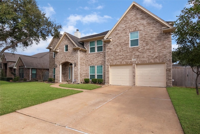 view of front of property with a garage and a front lawn